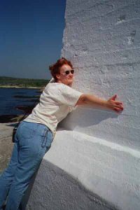 Karen hugs lighthouse